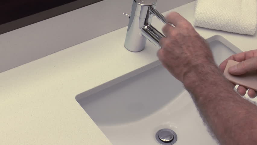 Man turns on water, lathers hands with soap, shuts faucet to conserve water, continues cleaning hands. 1080p