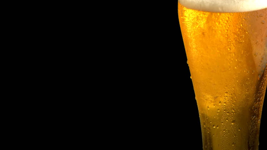 closeup of beer being poured into glass