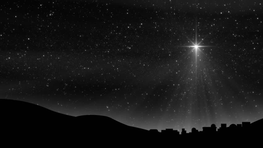 Seamless loop features the Bethlehem Christmas Nativity star with hundreds of twinkling stars in a colorful night sky silhouetting the town of Bethlehem. Light rays and sparkling particles.