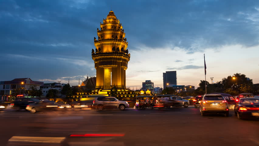 PHNOM PENH, CAMBODIA- DECEMBER 13, 2012: Sunset Timelapse of the Independence Monument in Phnom Penh, Cambodia at rush hour on December 13, 2012. Commuter traffic can be seen in the foreground. 