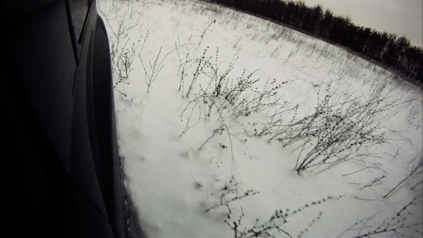 Driving through dirty, snowy lowland