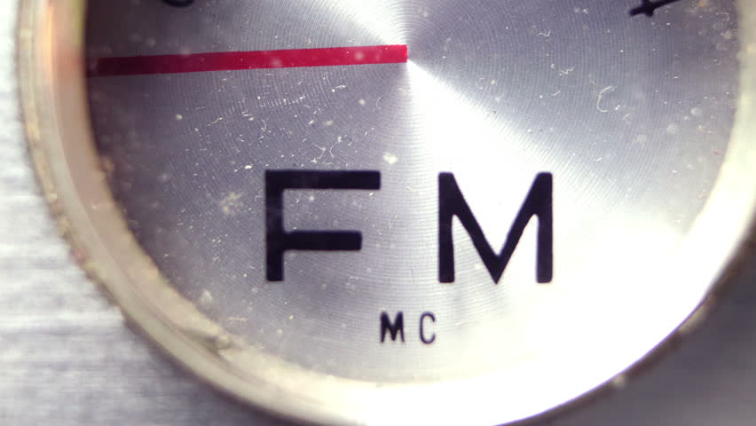 an old vintage portable FM and MW transistor radio with  the marker running through the different stations and frequencies