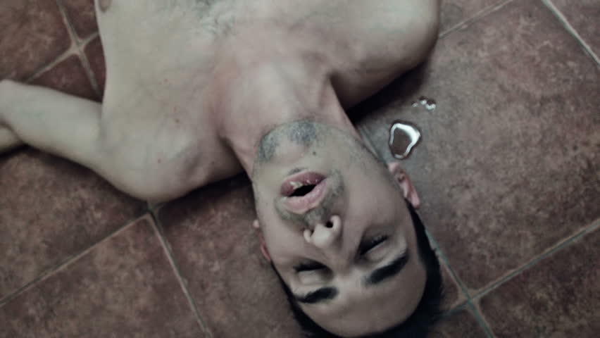 Drunk man on the floor vomiting 