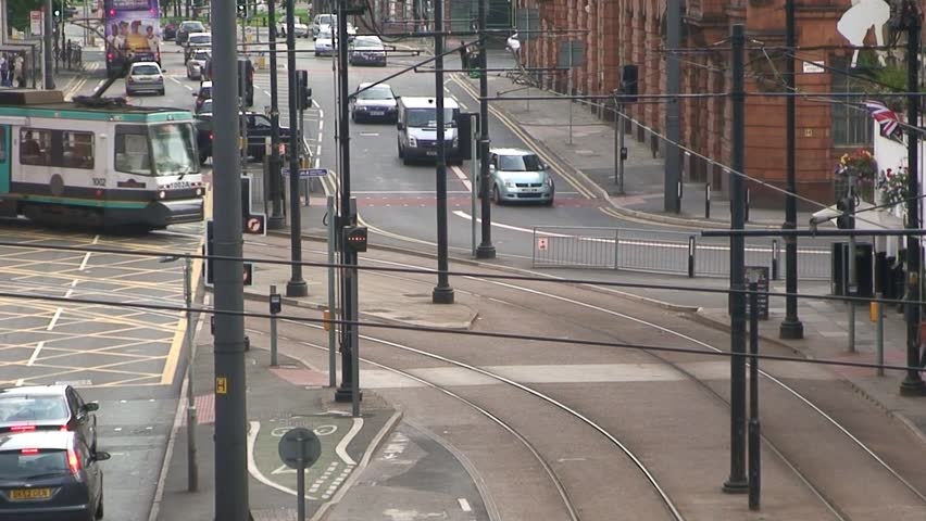 MANCHESTER, ENGLAND - CIRCA 2011: Manchester Metrolink tram crosses road.