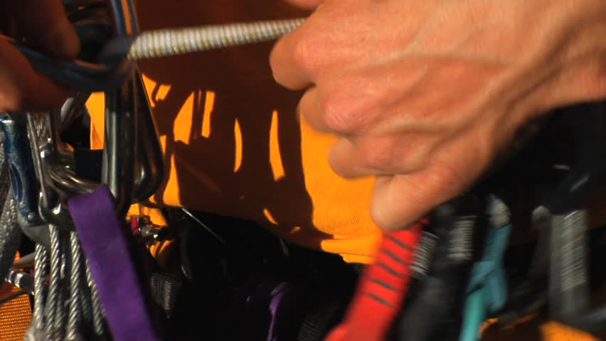 A man does a safety check of his climbing gear
