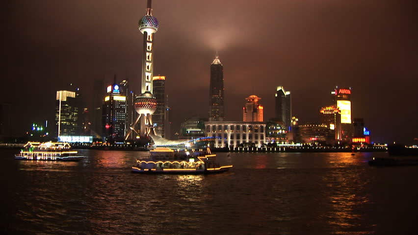 Lit up boat passes Pudong, Shanghai, China, River Huangpu, skyline at night