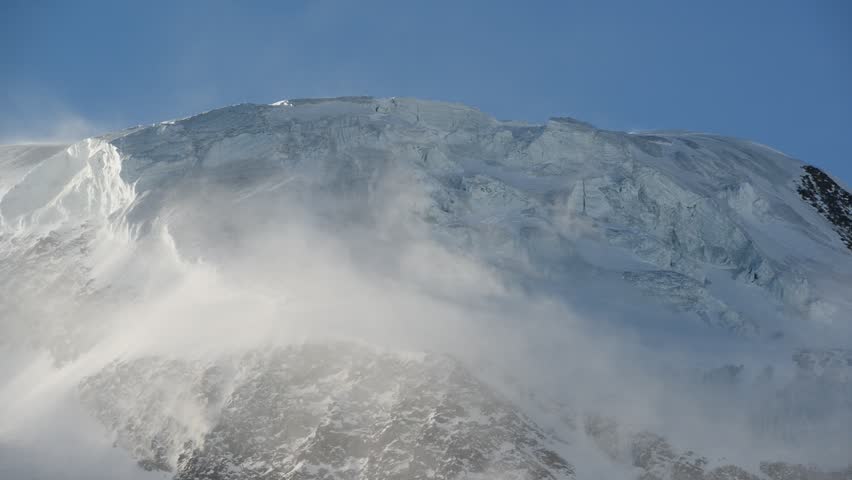 Strong wind over glacial mountain ridge of Alphubel mountain peak, Saas Fee, Valais, Switzerland