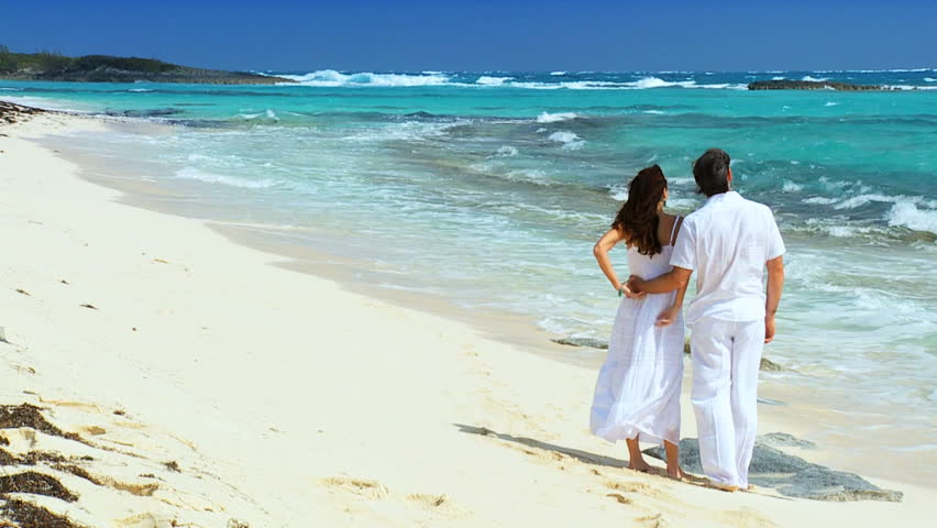 Attractive couple enjoying time together on a beautiful tropical island beach