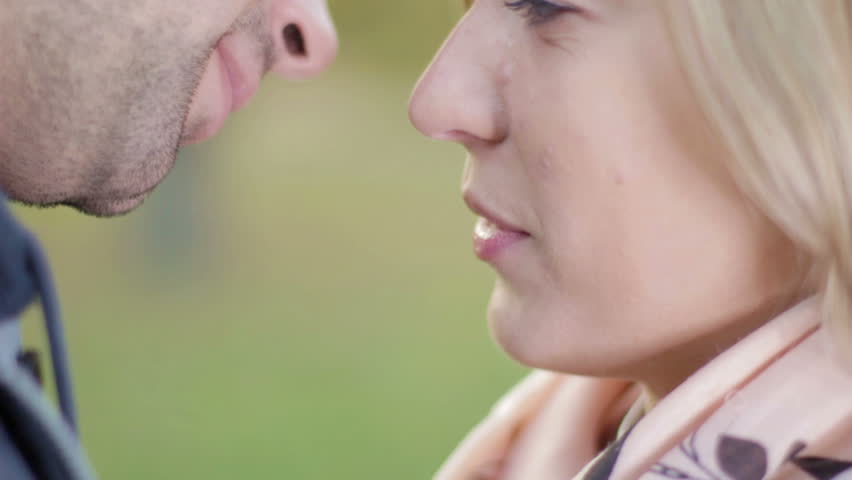 Close up portrait of young caucasian couple kissing.