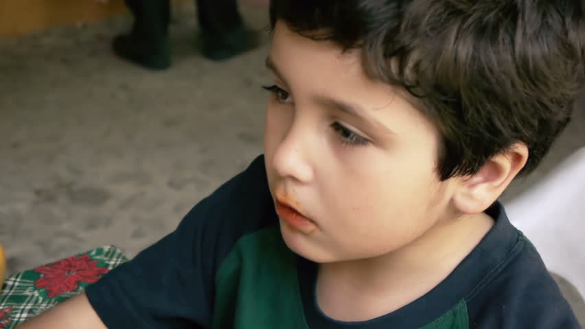 Hispanic Kid Eats Cheese Chip Snacks.  Unhealthy Eating , Angle Two.