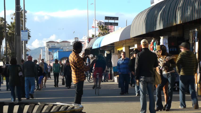 VENICE BEACH, CALIFORNIA - CIRCA 2011:  Tourists and locals walk on the boardwalk at Venice Beach, CA .
