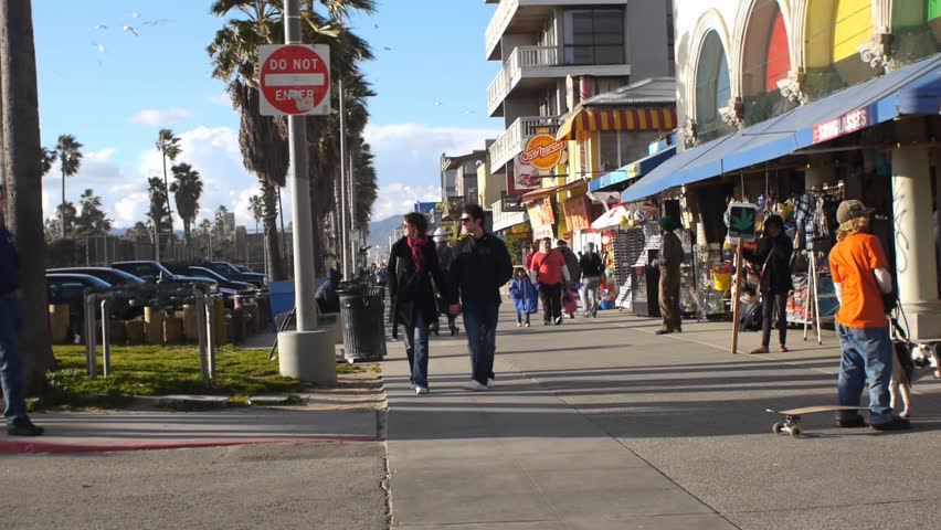 VENICE BEACH, CALIFORNIA - CIRCA 2011:  Tourists and locals walk on the boardwalk at Venice Beach, CA .