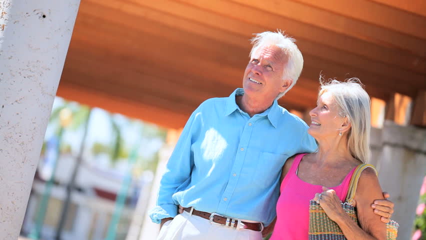 Older couple enjoying a stroll around an outdoor mall area