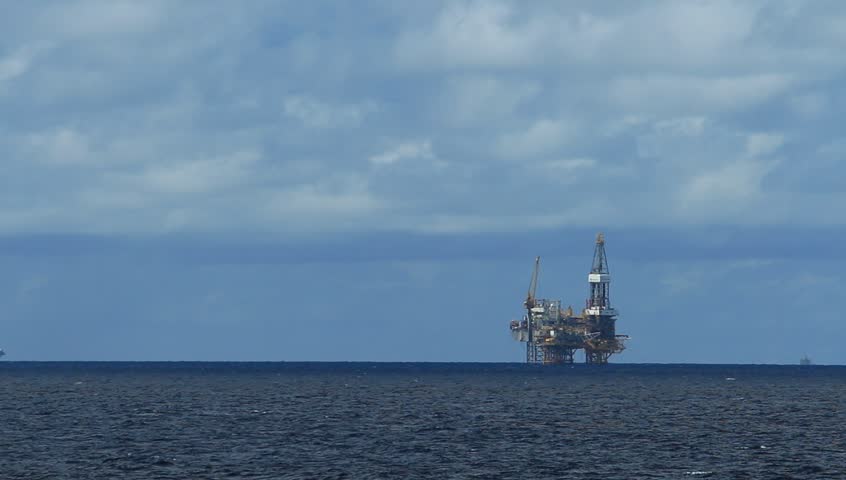 Offshore Jack Up Drilling Rig in The Middle of Ocean on Cloudy Day