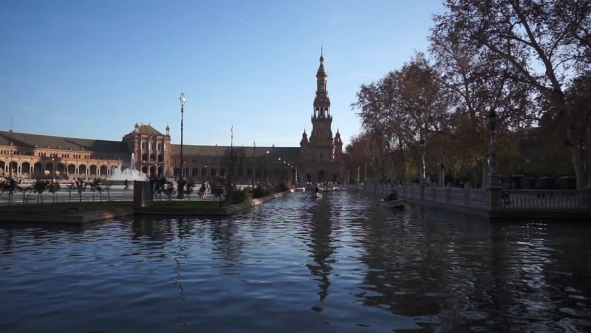 SEVILLE, SPAIN - JANUARY 6: Tourists enjoy a trip on boat on Plaza de Espana Seville on Jan 6, 2013 It was built in 1928 for the Ibero-American Exposition of 1929 designed by architect Anibal Gonzalez