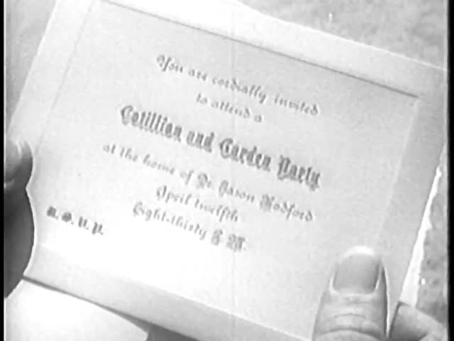 Close-up of person holding invitation card