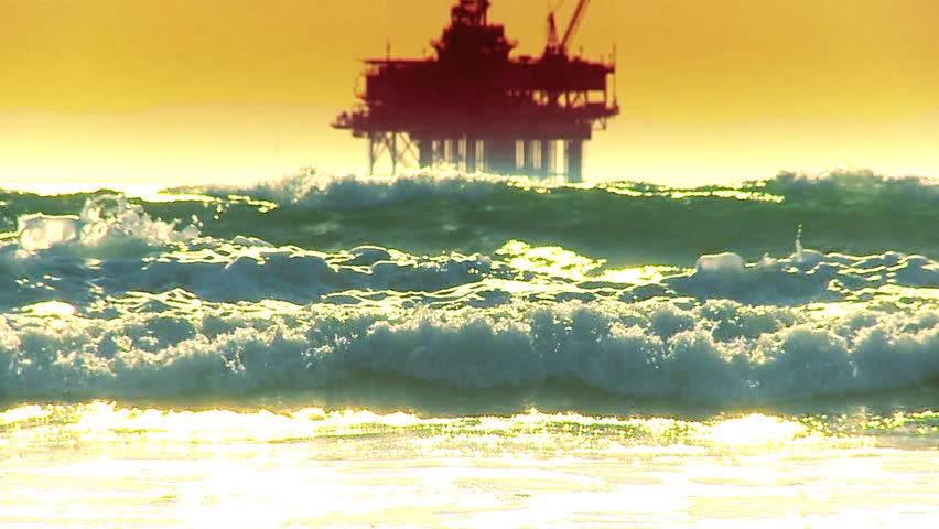 Oil platform in the sea at sunset
