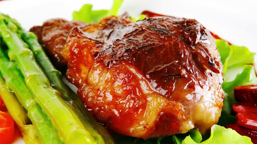 served roasted beef meat with asparagus on white dish slow motion  hidef