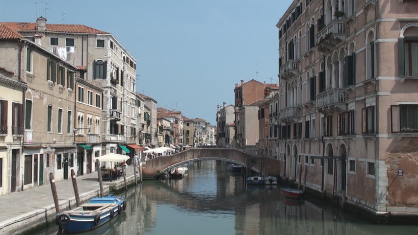 One of many canals in the city of Venice with ta typical bridge