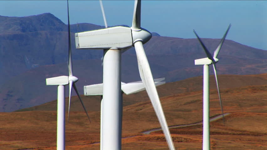 several wind turbines on mountain close up