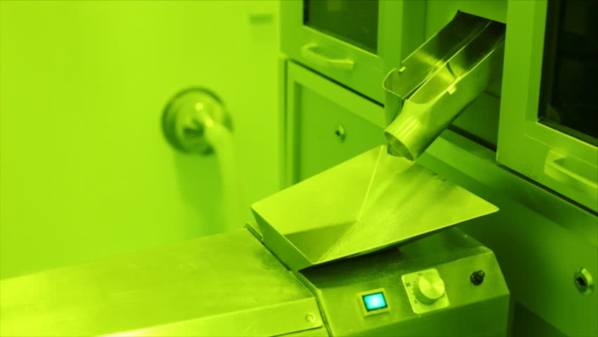 Pills falling out of pill manufacturing machine. Special Light and air conditions in the room.
