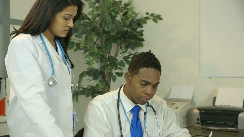 A young African American physician expresses frustration or exasperation to a colleague who tries to console or reason with him.
