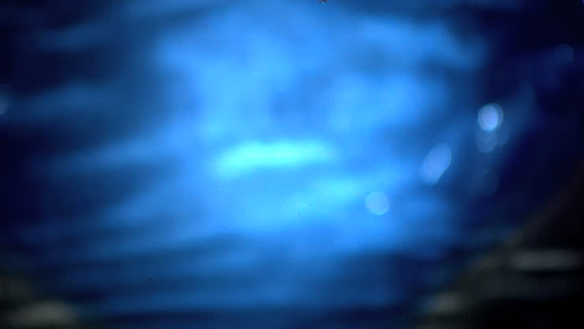 Water drops falling in water in slow motion
