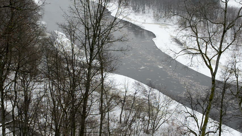 neris river with floe flowing downhill in winter park