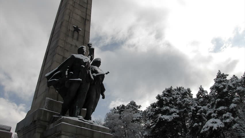 Time lapse of the sky behind a freedom monument during the winter.