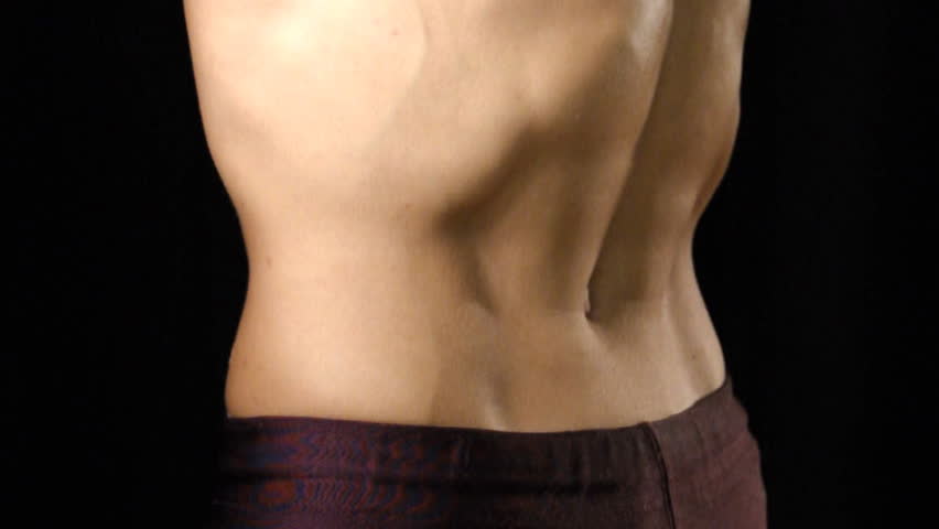 Man flexes his muscular abs on closeup shot of mid-section