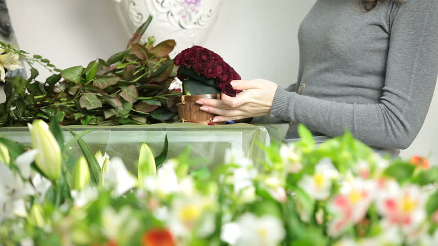 Florist Creating Red Roses Bouquet Arranged in Heart Shape In Flower Shop