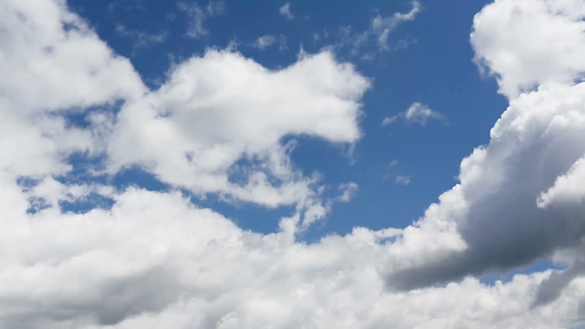 Time lapse clip of white fluffy clouds over blue sky