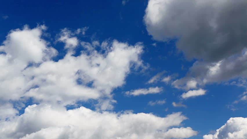 Time lapse clip of white fluffy clouds over blue sky