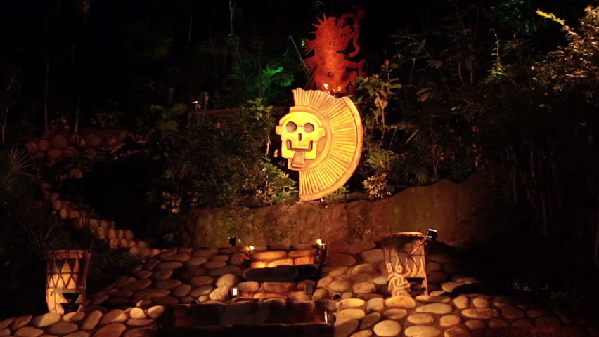 Mayan temple pyramid replica night torch flames. Tourism and tourist display of ancient Mayan cultures, costumes and actions.  Portraying ancient inhabitants of Mexico and central America.