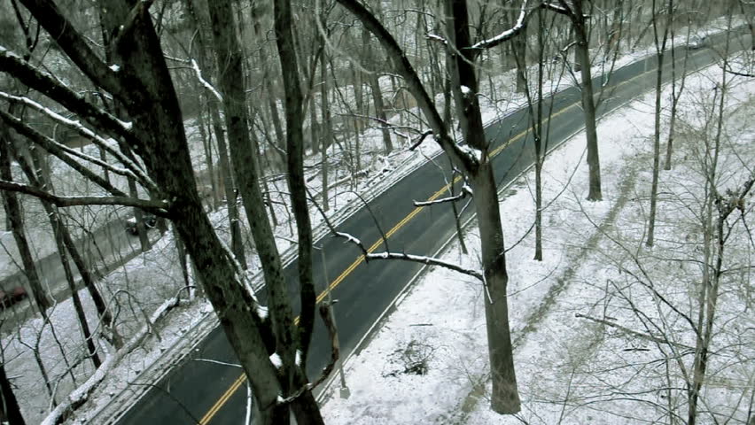 Winding Road. Cars pass down a winding winter road in Washington D.C.