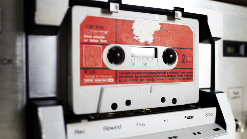 sequence of old audio cassettes in a retro tape player
