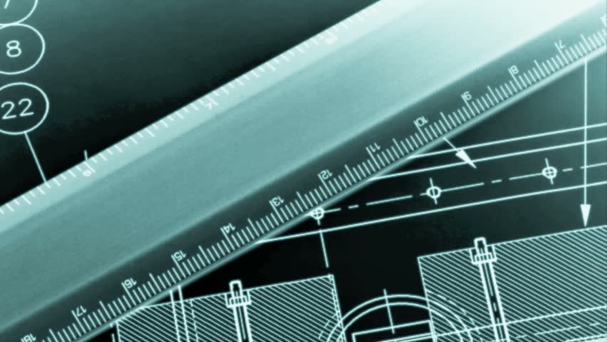 Drafting compass and ruler against a blueprint