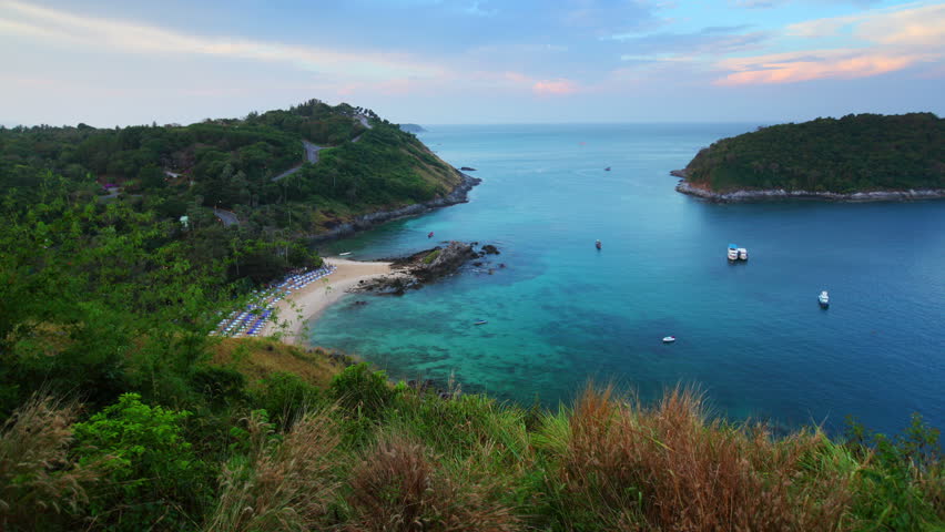 Time lapse of sunrise on tropical beach in a blue lagoon. Ya Nui beach. Phuket, Thailand