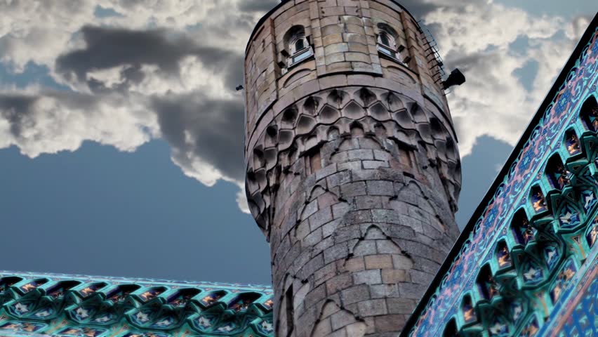 Minaret on the background of clouds in fast motion