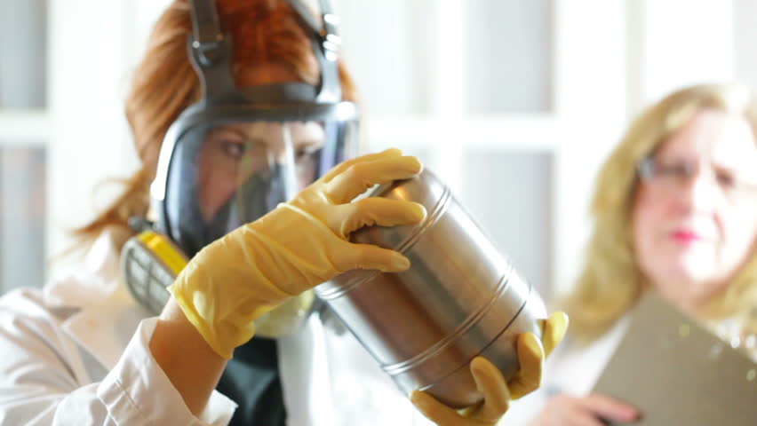 Female scientist looking at a cannister