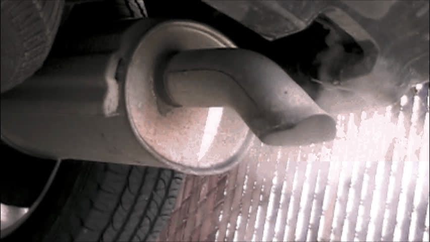 Exhaust steam pollution from a tailpipe of an idling car.