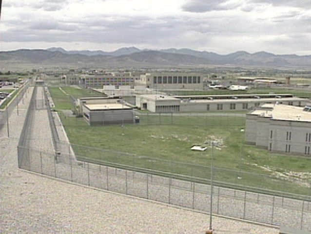 A wide pan of a prison exterior. 