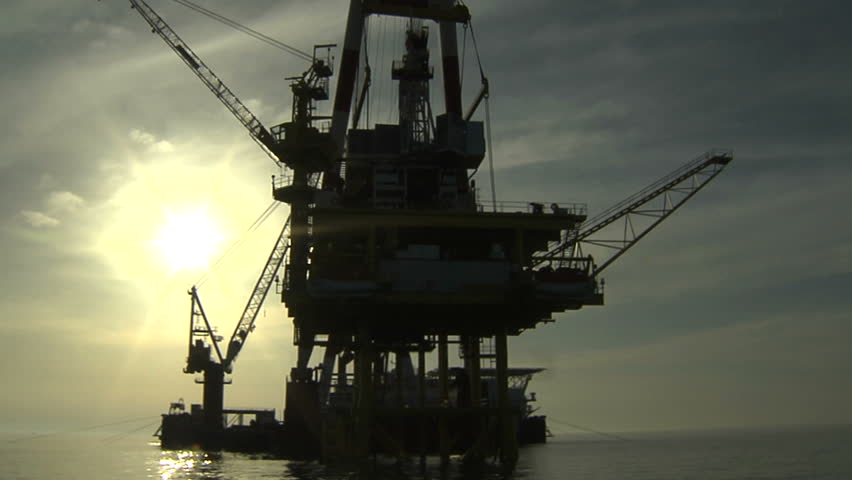 Oil rig against the sun