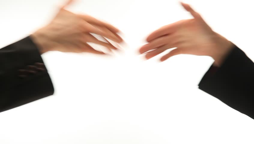 Businesswomen shake hands on white background