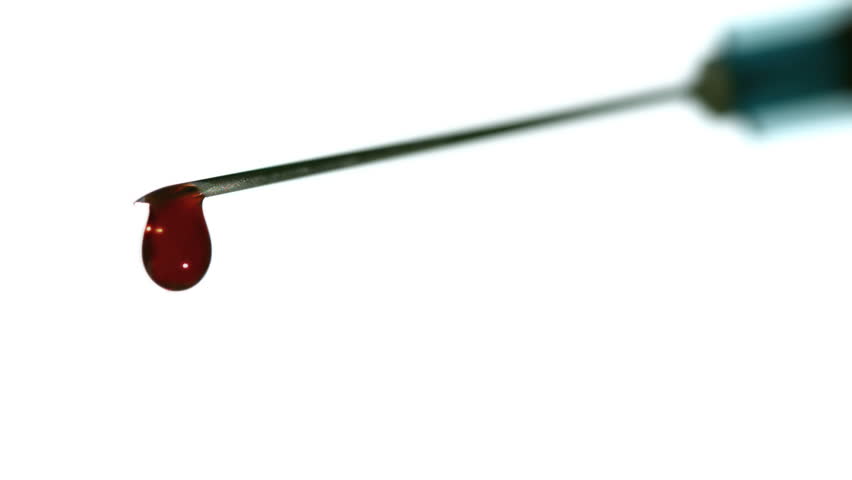 Drop of blood falling from syringe in slow motion