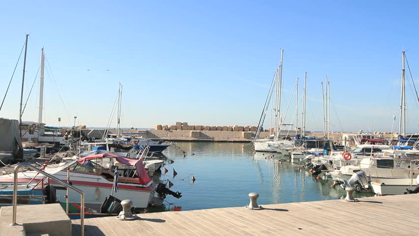 long shot of boats anchored at Jaffa port on still water
