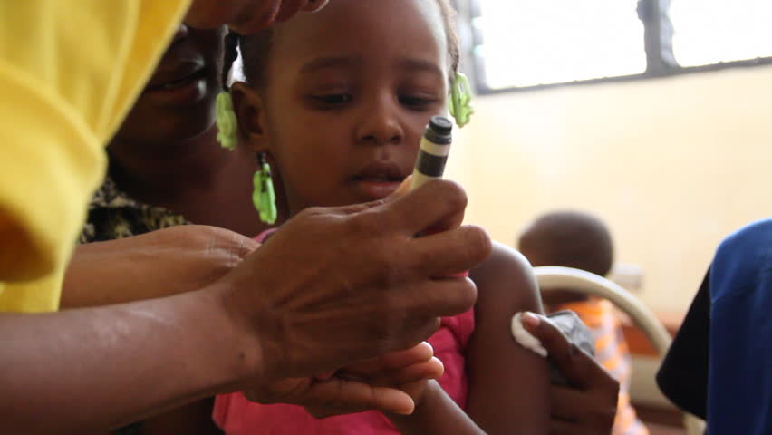 PORT AU PRINCE, HAITI - CIRCA MAY 2012: child receives fingernail mark after vaccination 