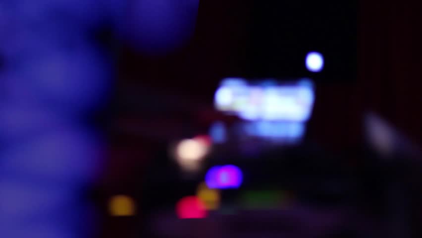 DJ performs, moves his hands, scratching the record