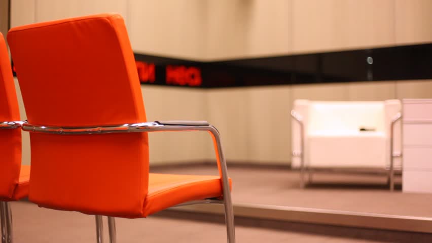 Leather chairs in conference hall with running line non-systematic announcement: opposition is glad about discussion in state duma