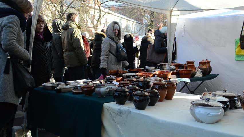VILNIUS, LITHUANIA - MARCH 02: People look at crockery pots goods in outdoor national spring fair event on March 02, 2012 in Vilnius. Traditional crafts and sell exhibition.